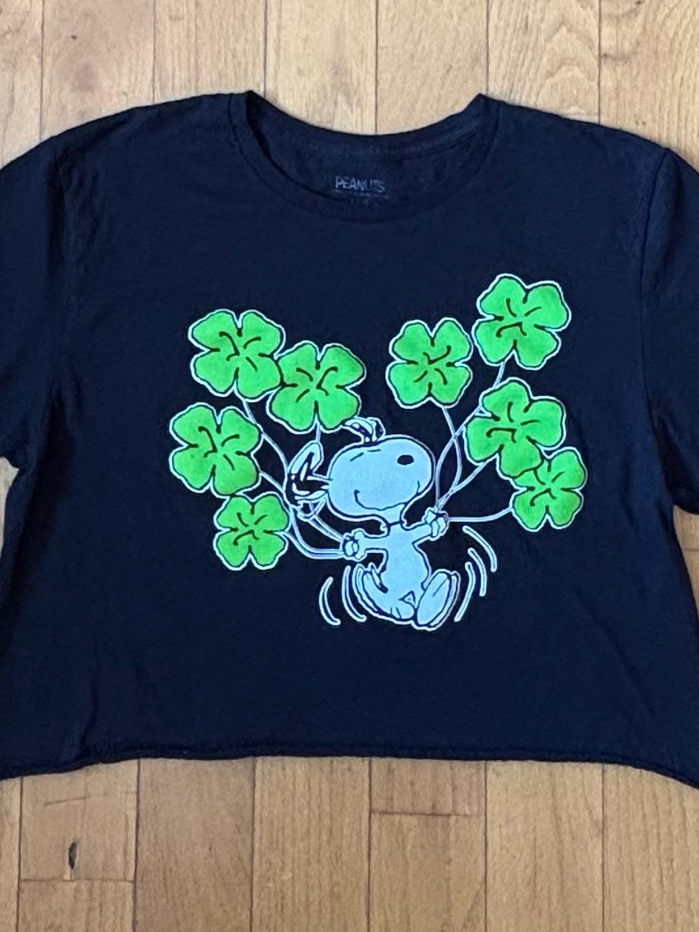 Peanuts Snoopy Women’s Black Graphic Tee with Green Clovers